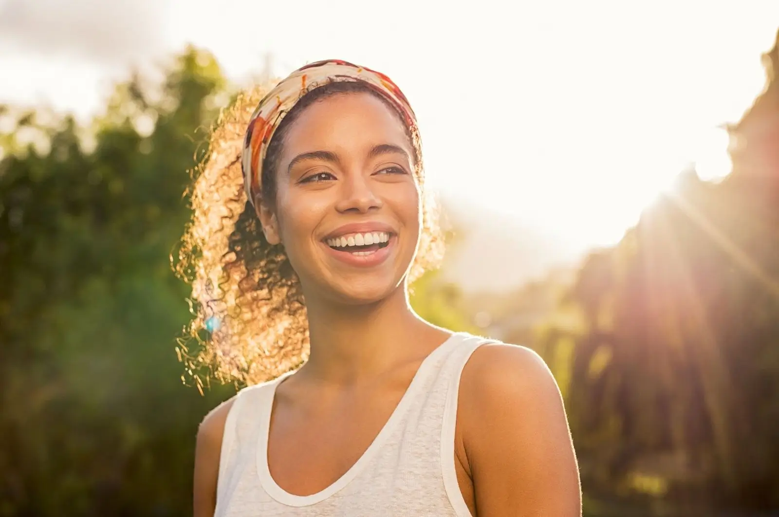 Woman smiling in warm evening sunlight